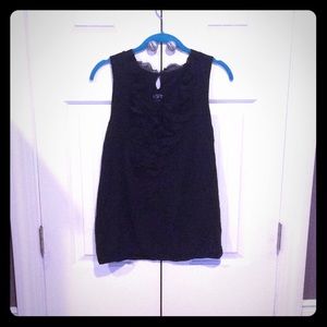 Black sleeveless top with ruffle front